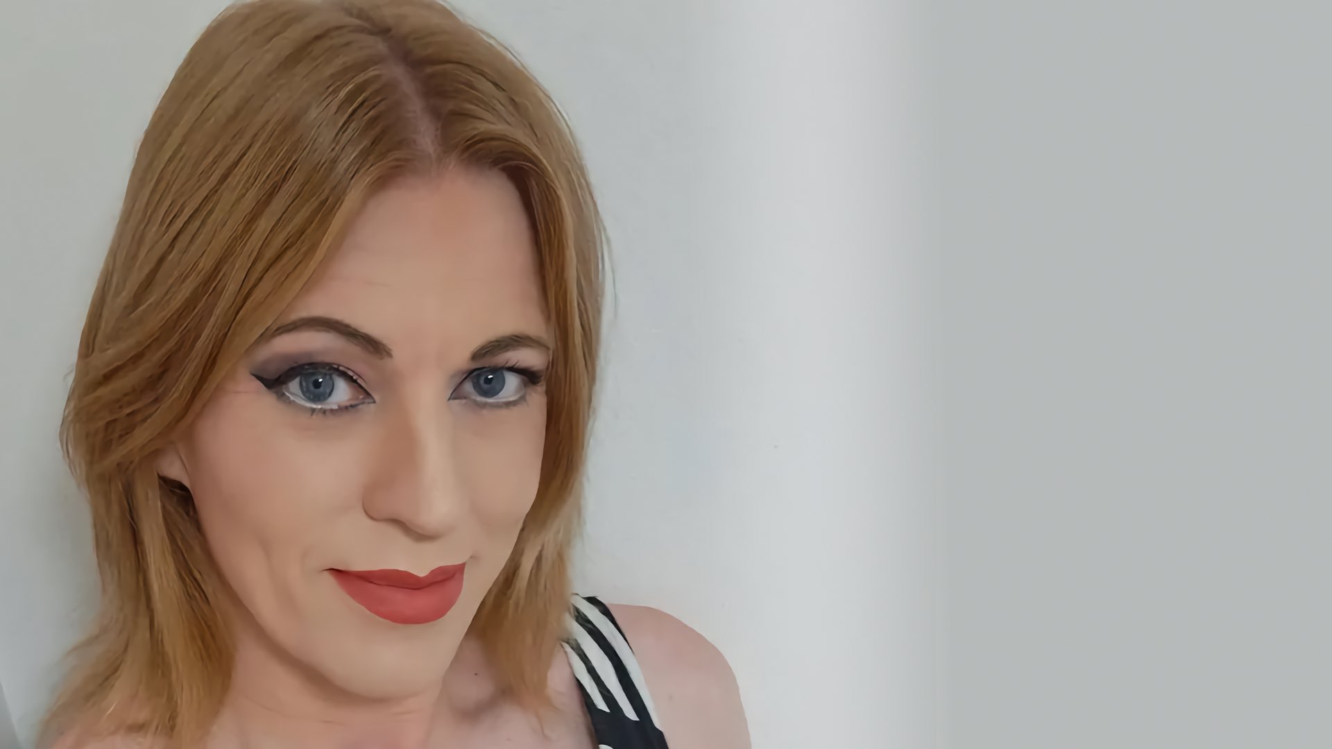 A head shot of Ami looking at the camera with a faint smile.